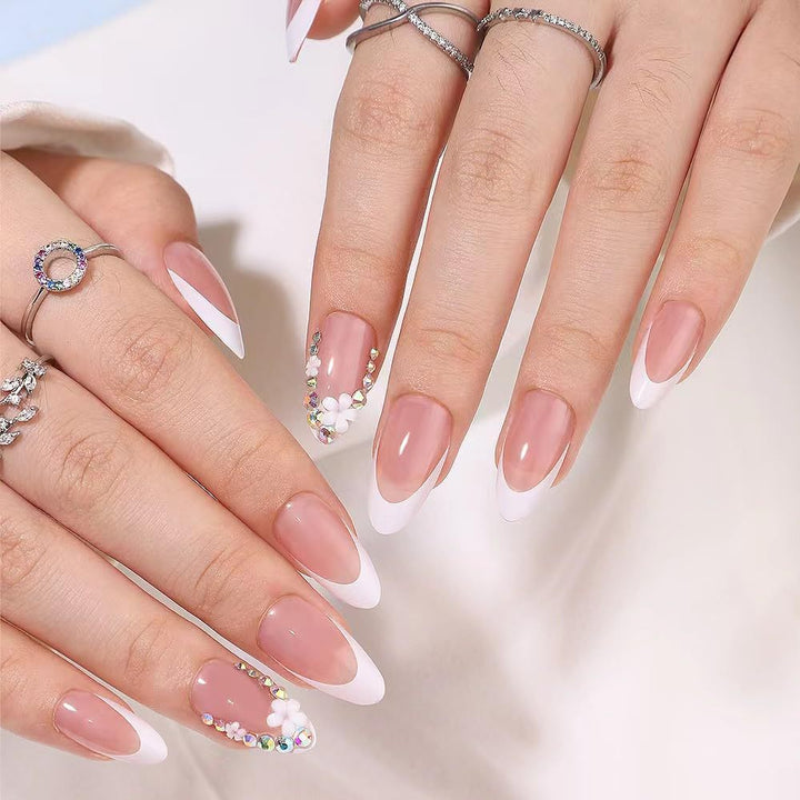 Artificial nails with elegant French tips and rhinestone details Stornfield