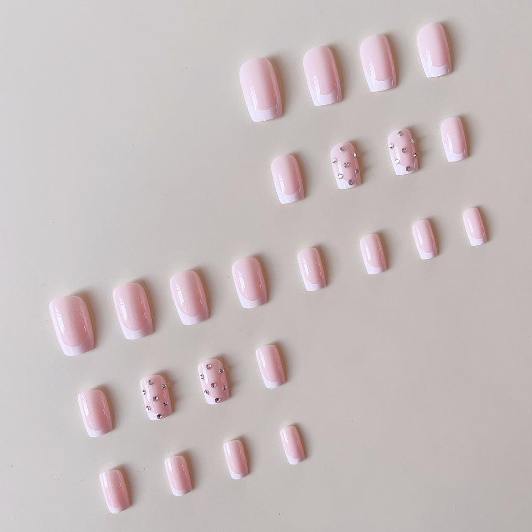 Artificial nail set with elegant rhinestones and French tip decorations Stornfield