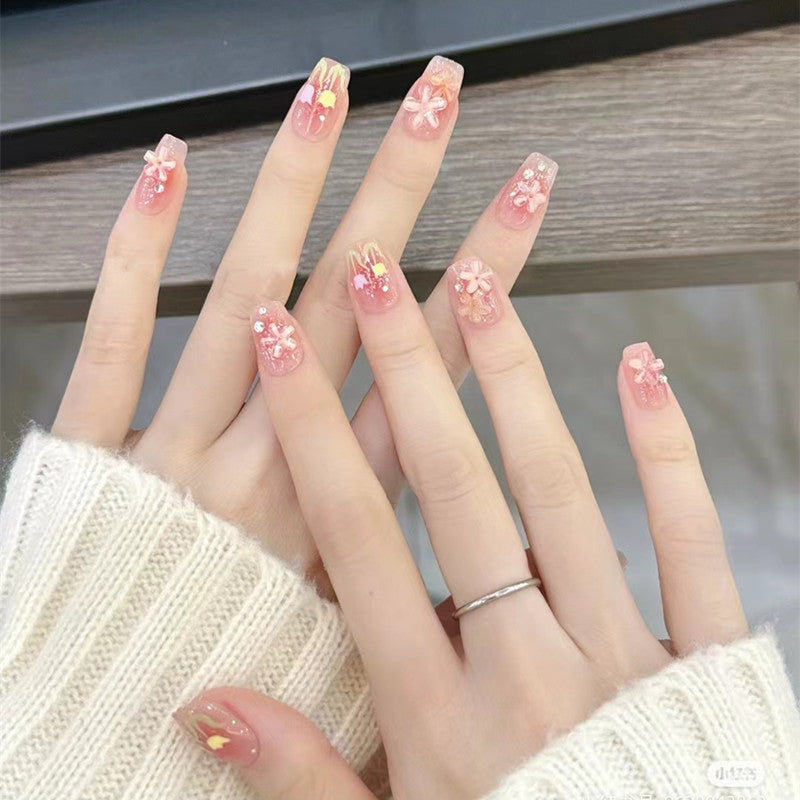 Glamorous artificial nails with delicate flower and glitter effects Stornfield