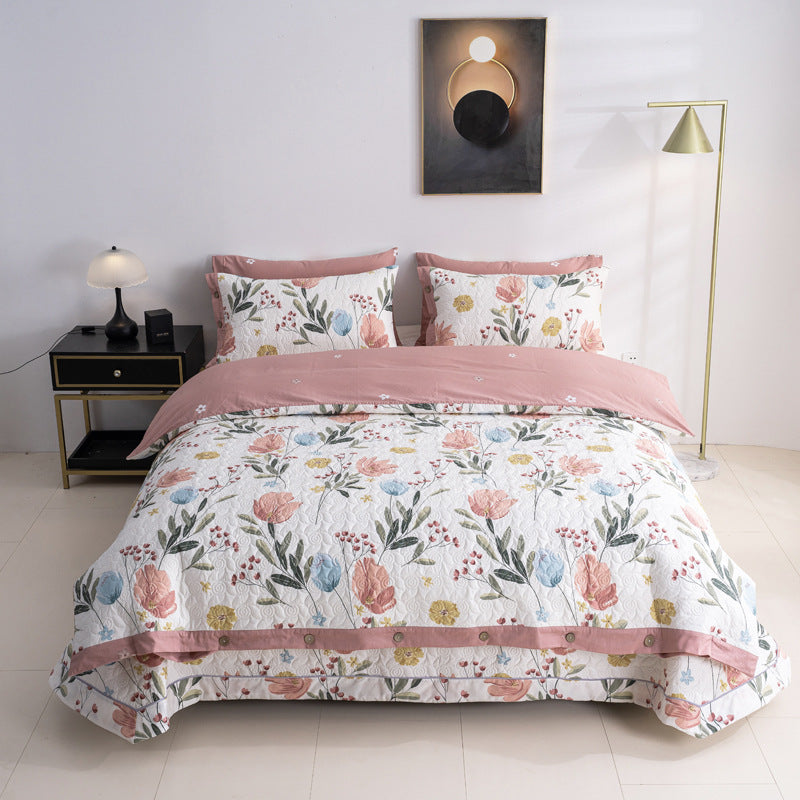Quilted bedspread and bedding set with floral print, reversible function and decorative button placket