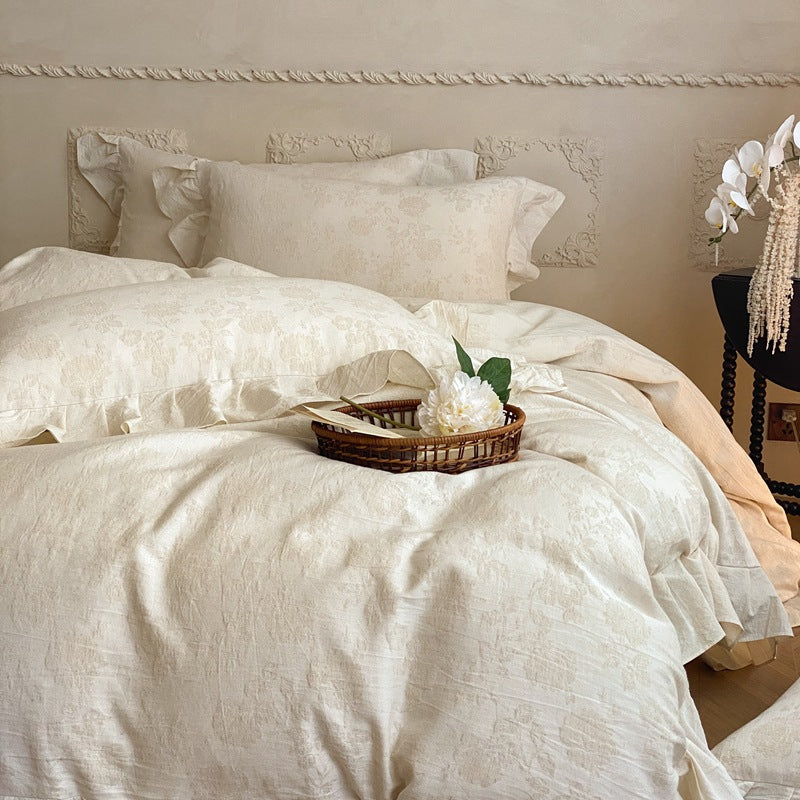 Jacquard bedding set with decorative ruffle border and floral relief