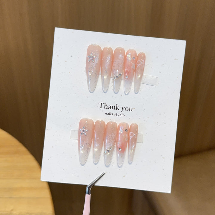 Artificial nails with filigree design and glitter accents Stornfield