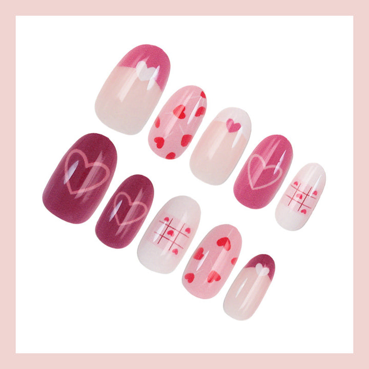 Acrylic nail set with romantic heart motif and creative patterns Stornfield