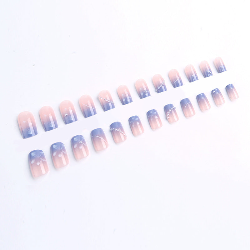 Nail set with elegant floral accents and glitter embellishments Stornfield