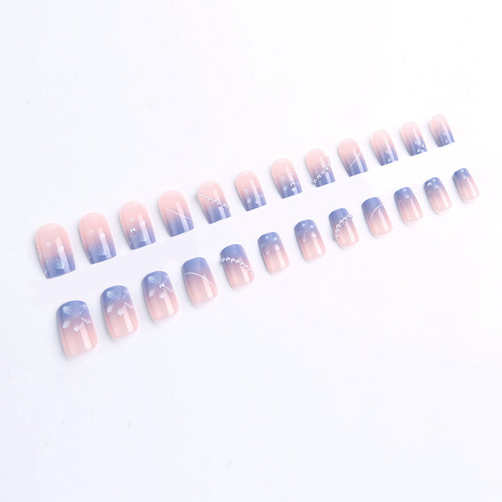 Nail set with elegant floral accents and glitter embellishments Stornfield