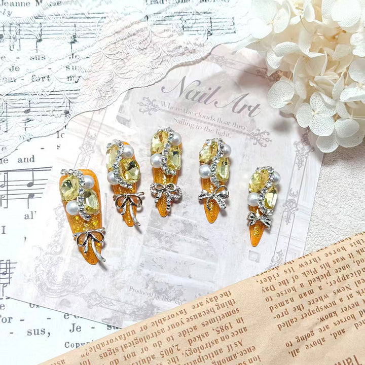 Glamorous artificial nails with rhinestones and pearl embellishments Stornfield