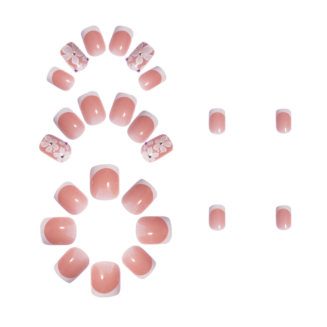 Artificial nail set with elegant French design and floral accents Stornfield