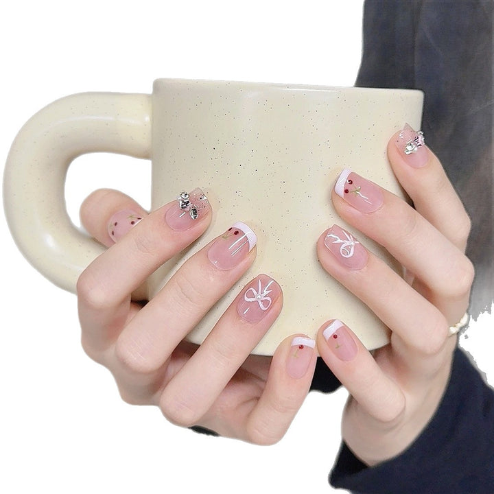 Decorative Press-On Nail Art with Floral and Bow Accents