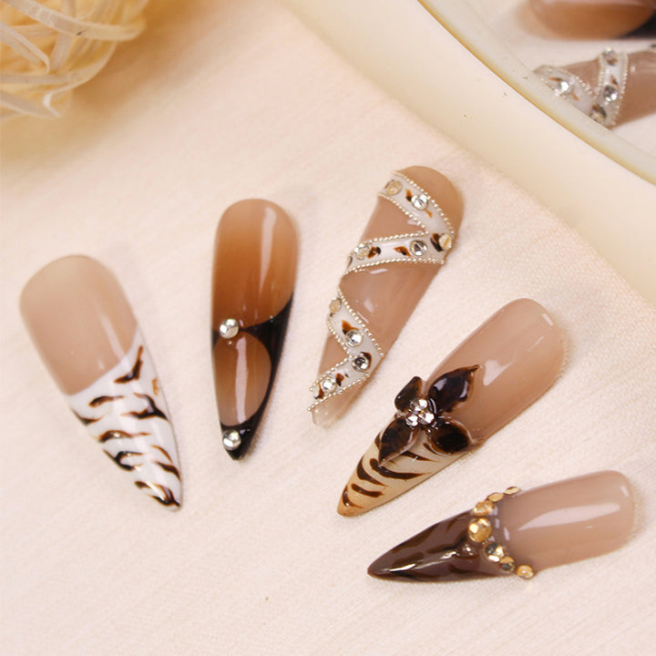 Artificial nails with extravagant designs and glitter accents Stornfield