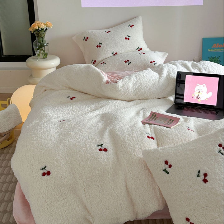 Cozy Sherpa blanket with embroidered teddy and cake motifs