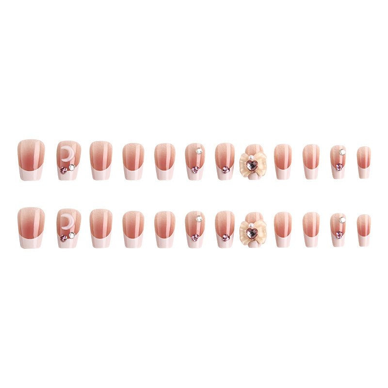 Artificial nail set with elegant floral decorations and glitter accents Stornfield