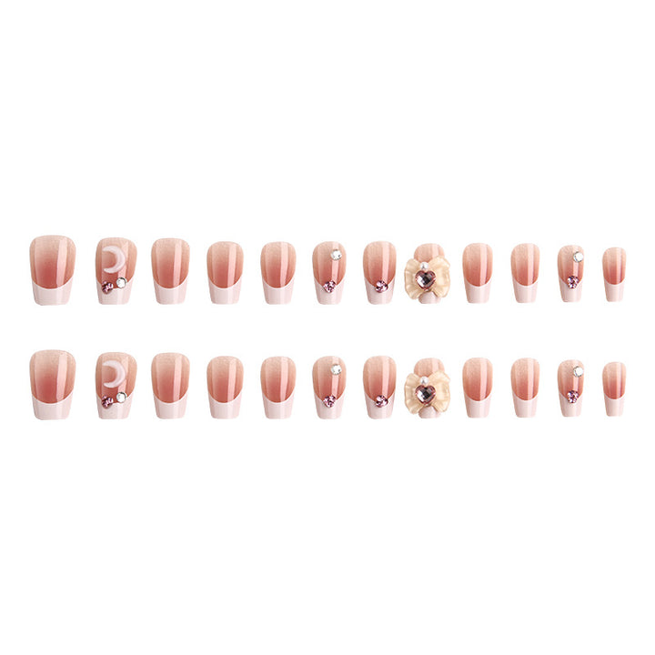 Artificial nail set with elegant floral decorations and glitter accents Stornfield