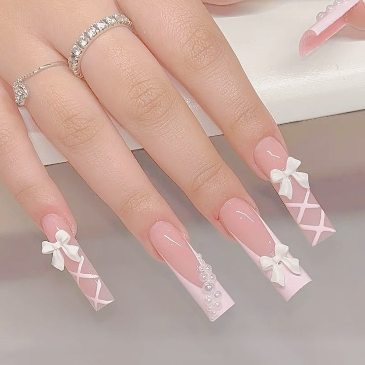 Artificial nail set with elegant 3D bows and pearl embellishments Stornfield
