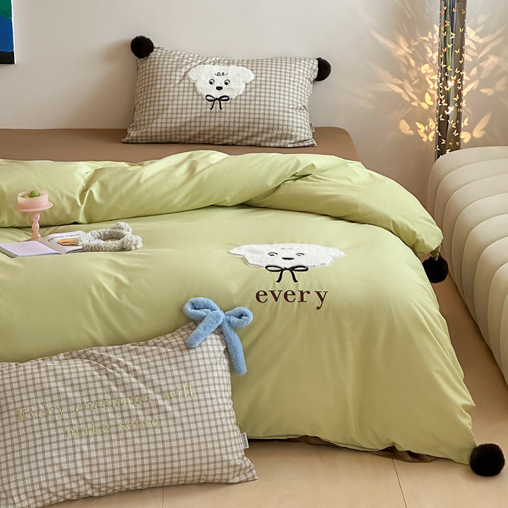 Children's bedding set with striped duvet cover, checkered decorative pillow, and plush application