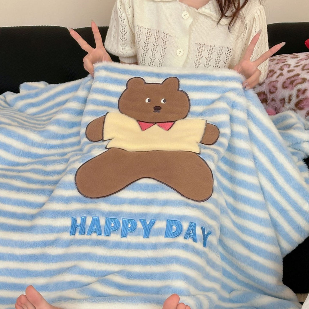 Plush cuddle blanket with striped texture, pom-pom corners & embroidered bear motif