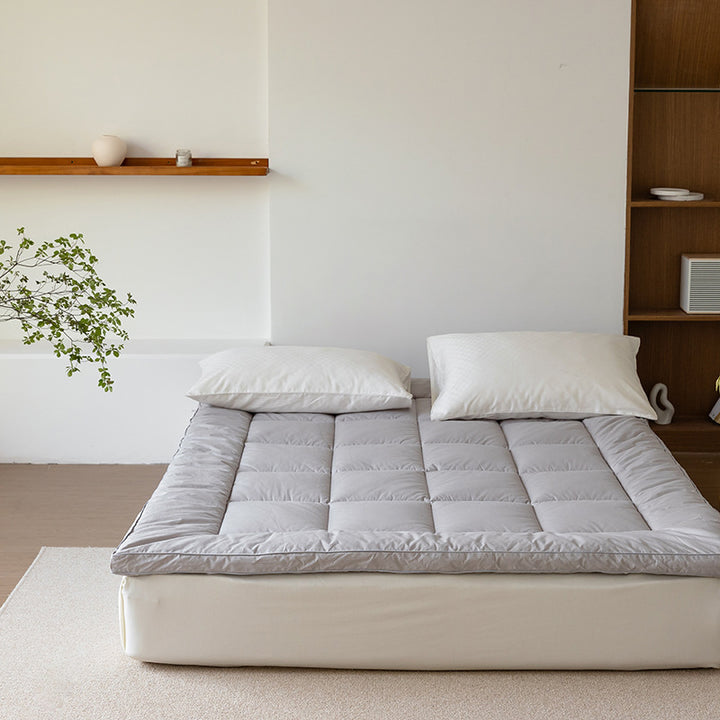 Padded mattress topper with a light down look and breathable hollow fiber filling