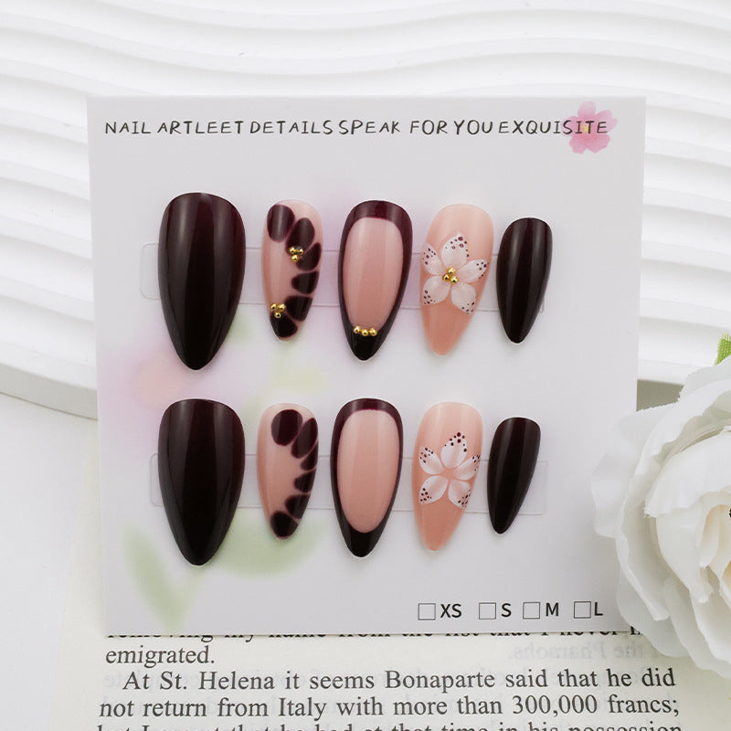 Acrylic nail set with elegant floral patterns and glamour accents Stornfield