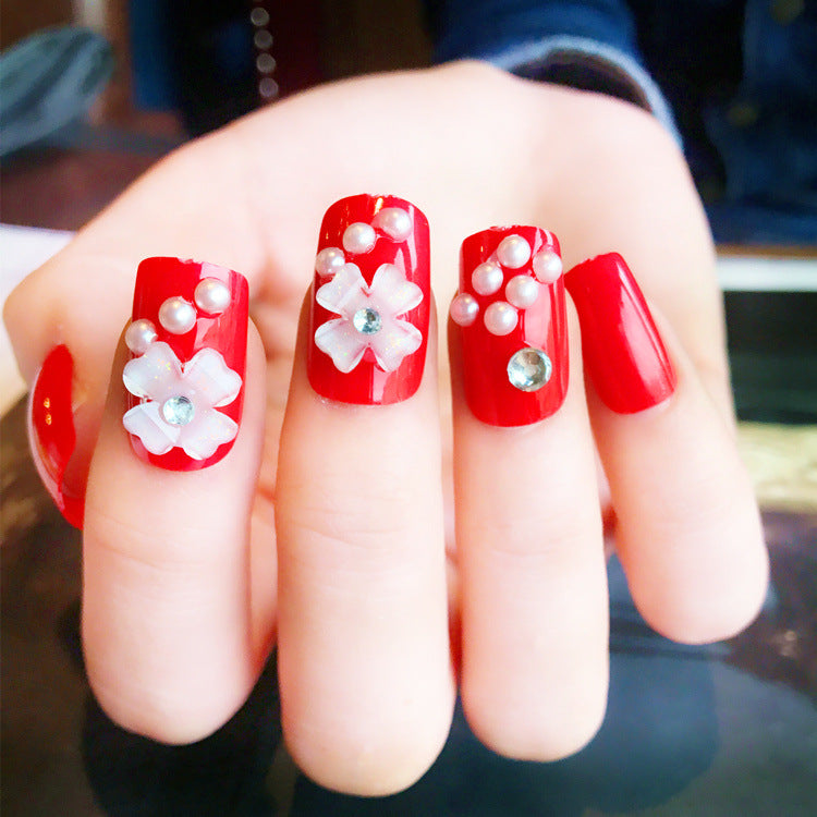 Artificials nails with sparkling rhinestone accents and elegant flower embellishments Stornfield