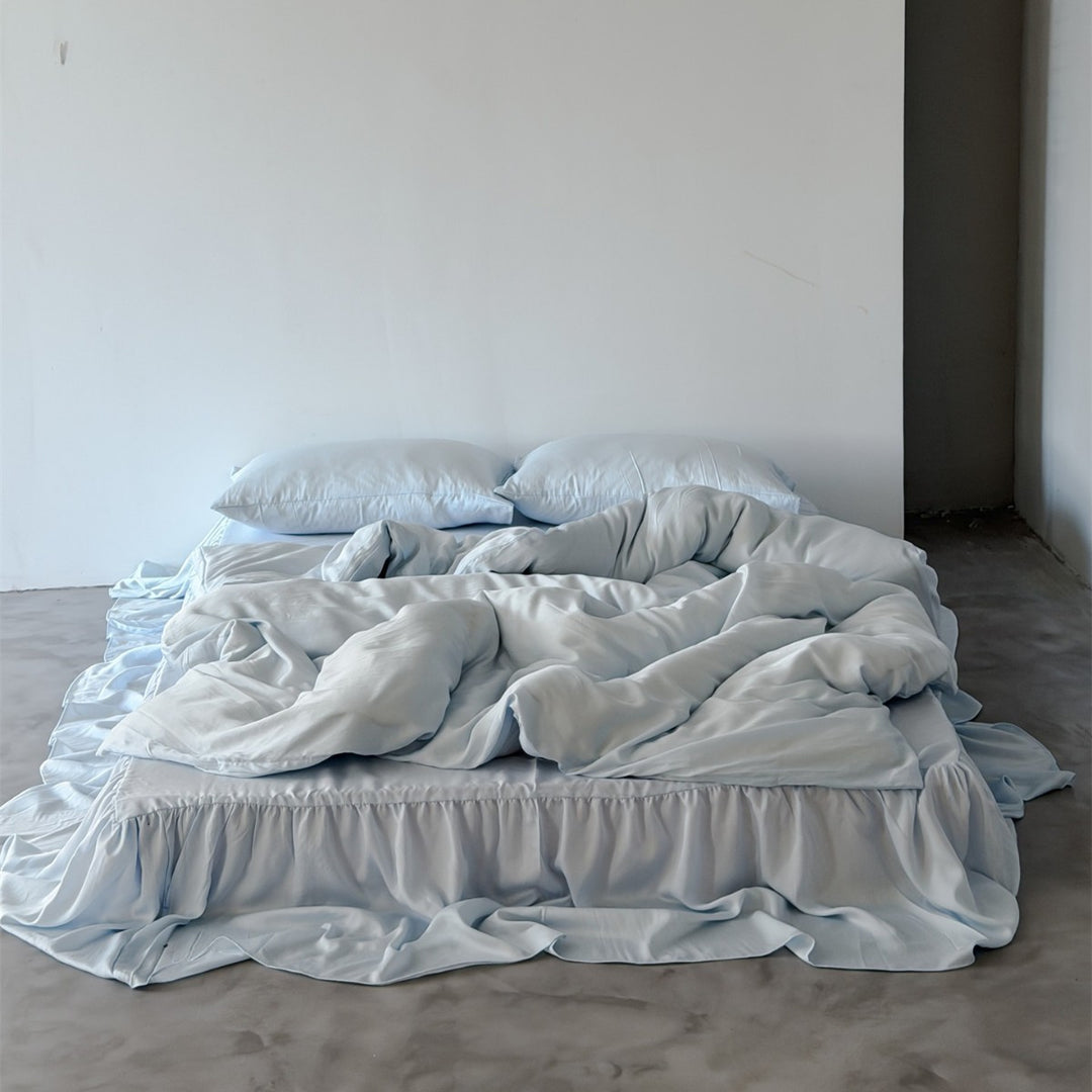 Bedding set with voluminous bed skirt and soft satin finish