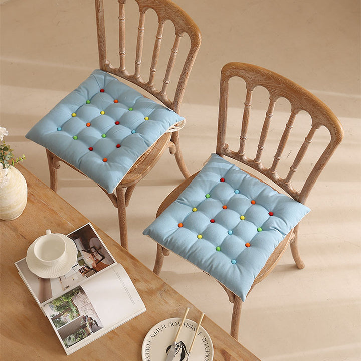 Padded quilted seat cushion with colorful button applications and non-slip underside Stornfield
