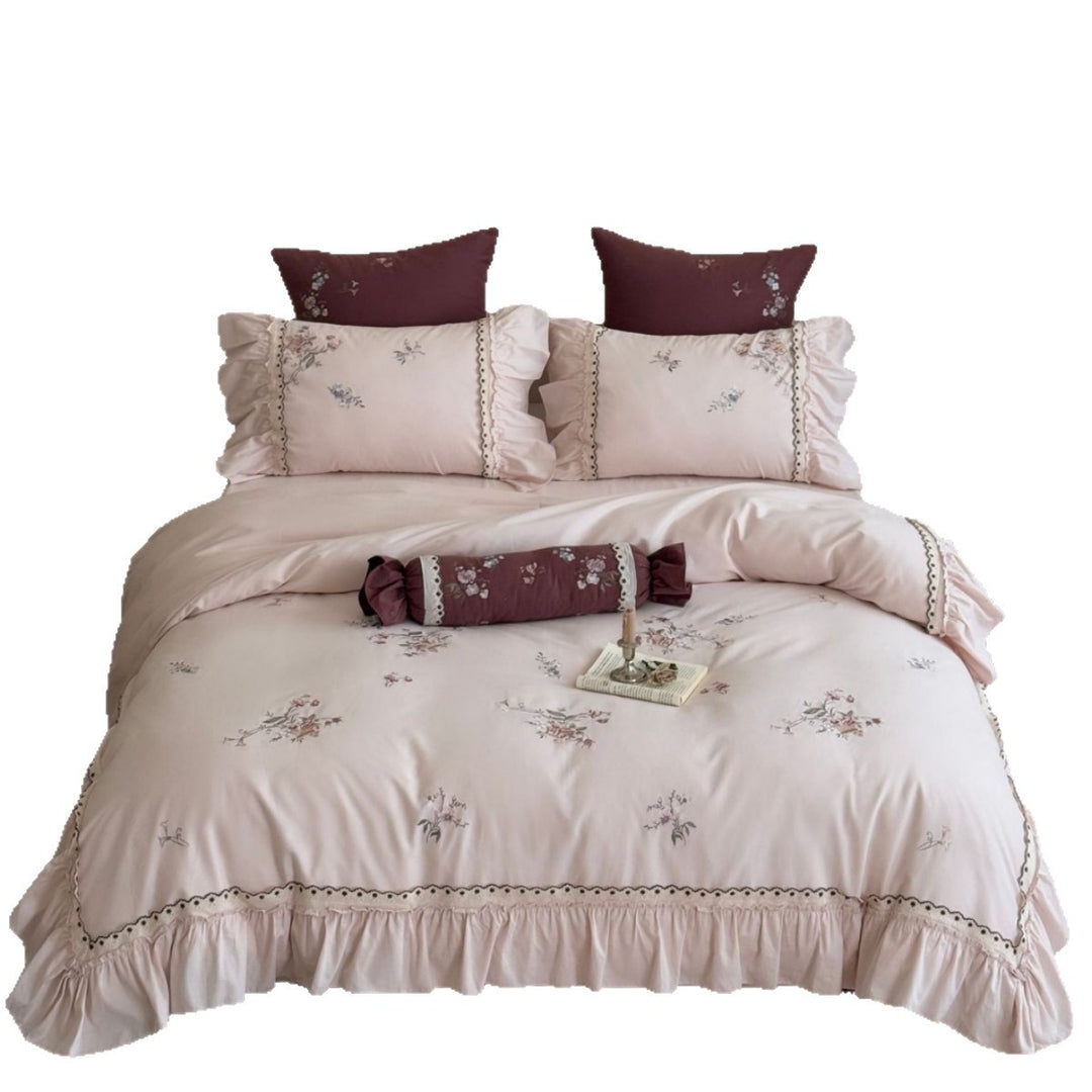 Romantic bedding set with ruffle, floral embroidery and decorative roll