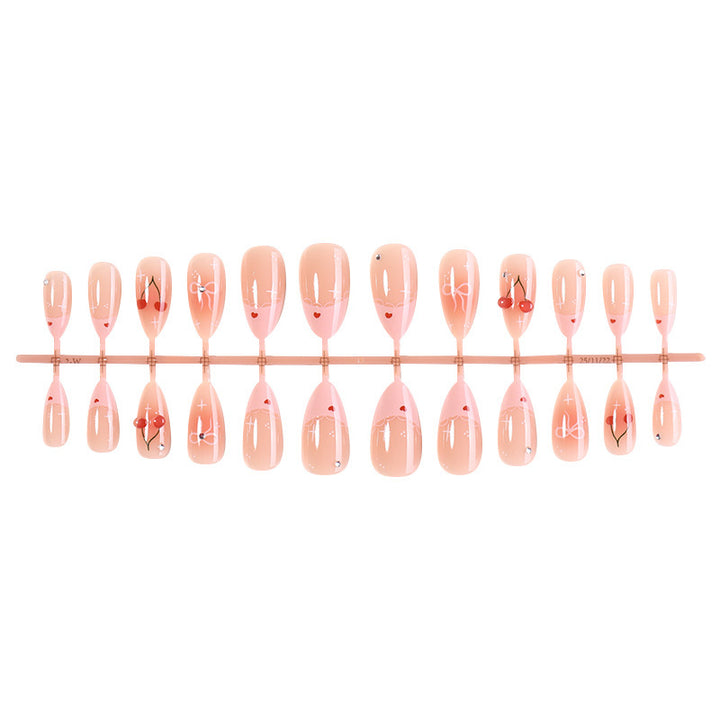 Artifical nails with playful heart and bow designs Stornfield