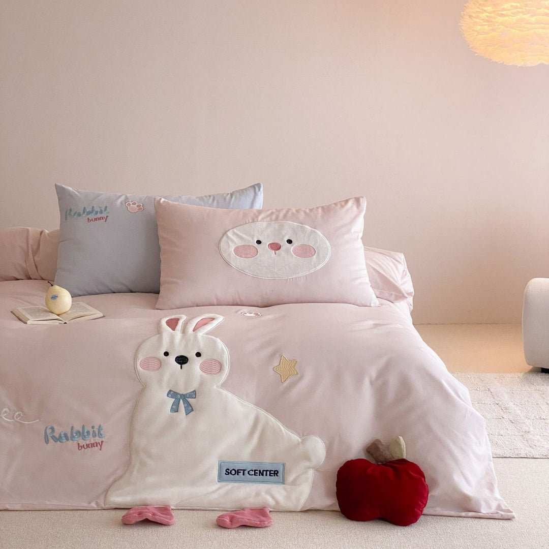 Children's bedding set with appliquéd duck figure, embroidered details, and extra soft microfiber cover