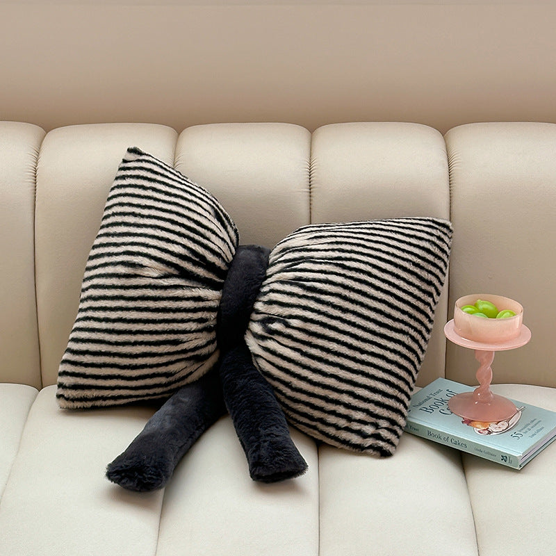 Cuddle cushion in bow shape made of plush with striped texture