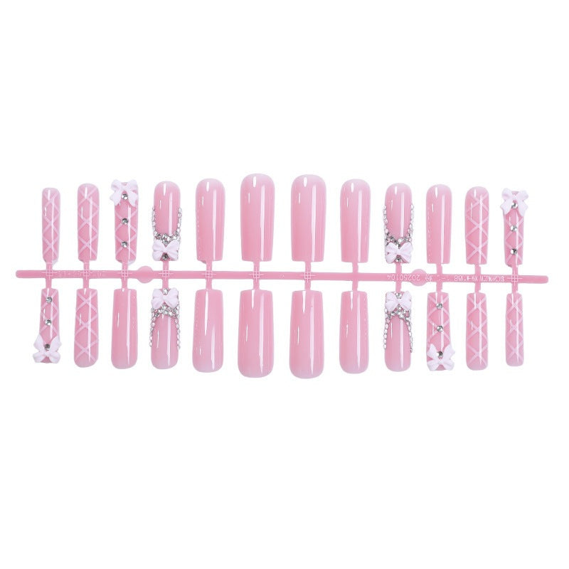 Acrylic nail set with elegant bow and glitter accents Stornfield