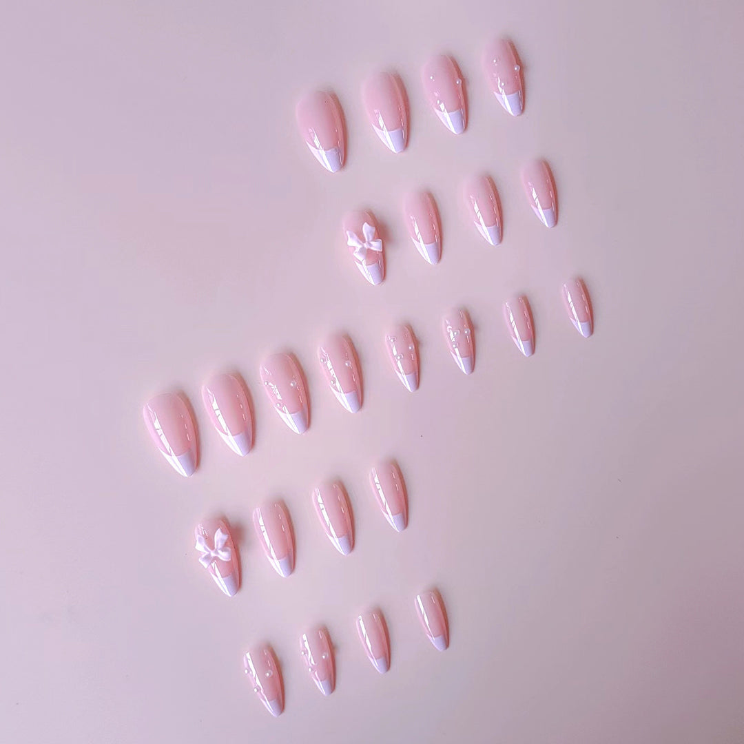 Artificial nail set with shimmering 3D bows and elegant pearl accents Stornfield