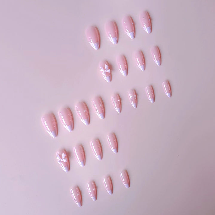 Artificial nail set with shimmering 3D bows and elegant pearl accents Stornfield