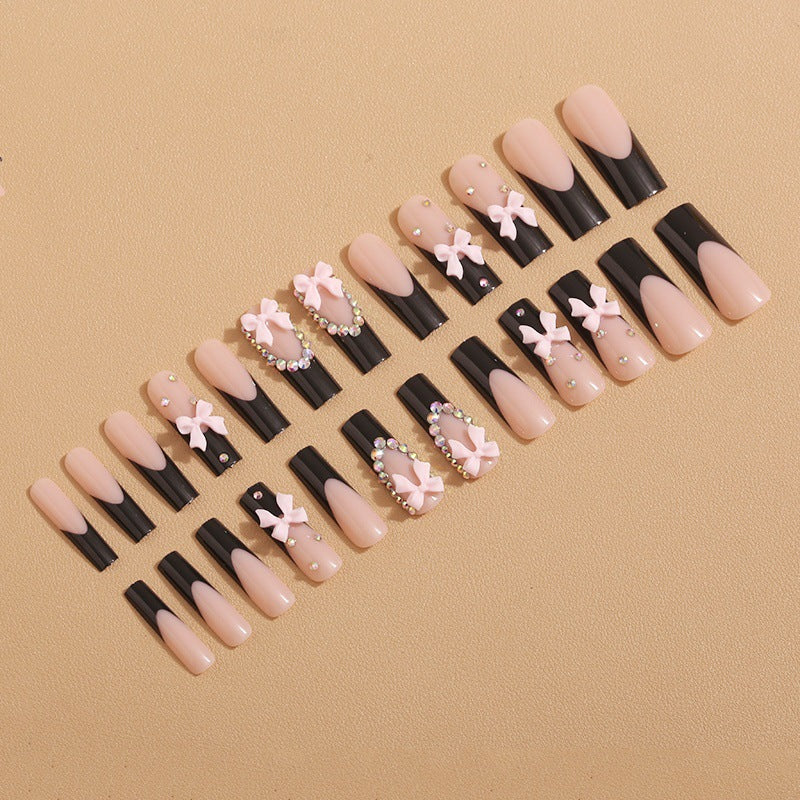 Artificial nails with elegant bows and rhinestone embellishments Stornfield