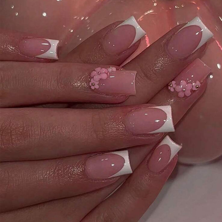 Acrylic nail set with elegant French tips and decorative accents Stornfield