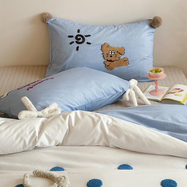 Children's bedding set with striped duvet cover, checkered decorative pillow, and plush application