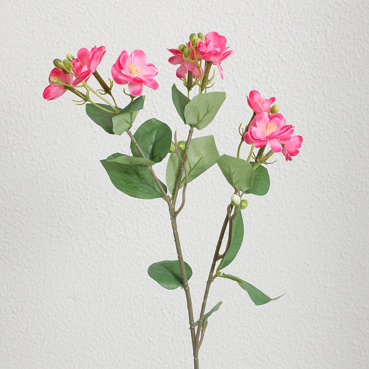 Artificial flower branch with vibrant pink flowers