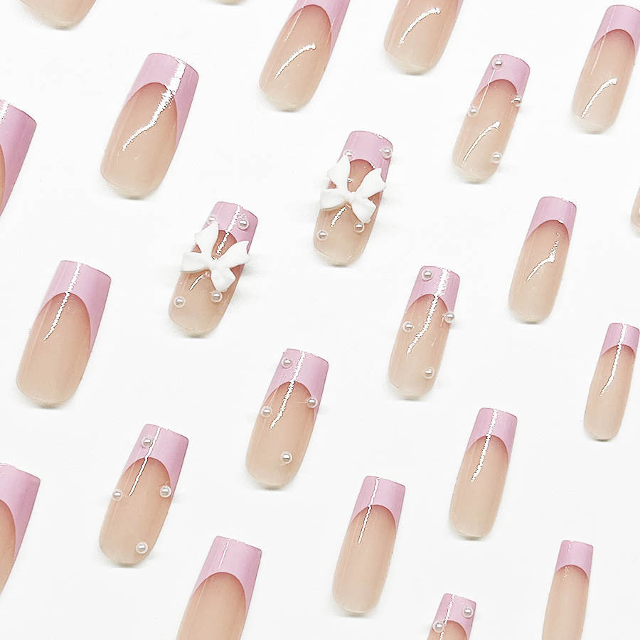 Artificial nail set with romantic bow and pearl embellishments Stornfield