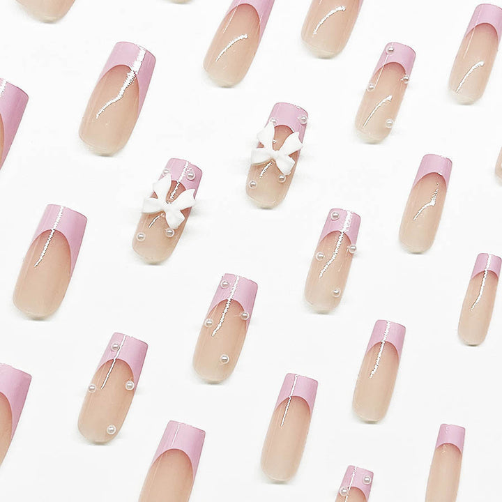 Artificial nail set with romantic bow and pearl embellishments Stornfield