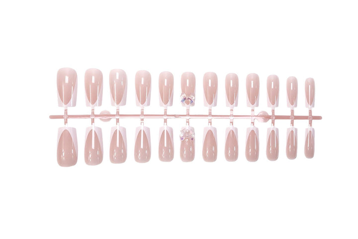 Artificial nail set with luxurious French tips and elegant jewelry embellishments Stornfield