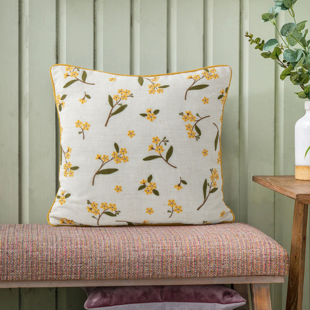Decorative embroidered cushion cover made of linen blend with floral yellow flower appliqué and piping Stornfield