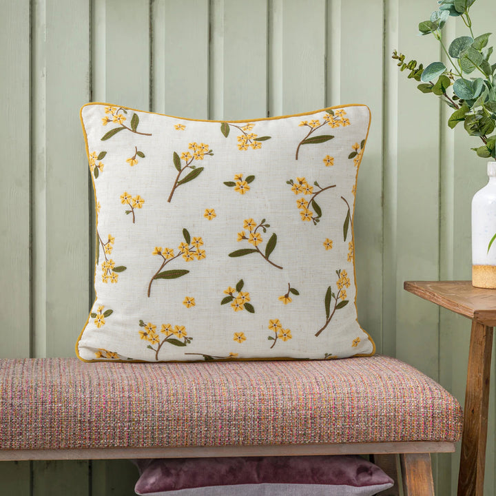 Decorative embroidered cushion cover made of linen blend with floral yellow flower appliqué and piping Stornfield