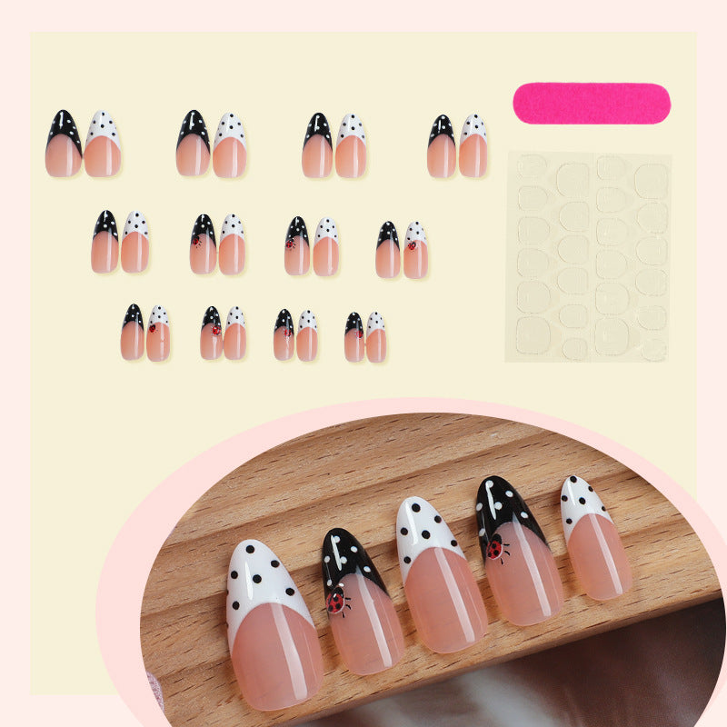 Acrylic nail set with polka-dotted accents and sparkling details Stornfield