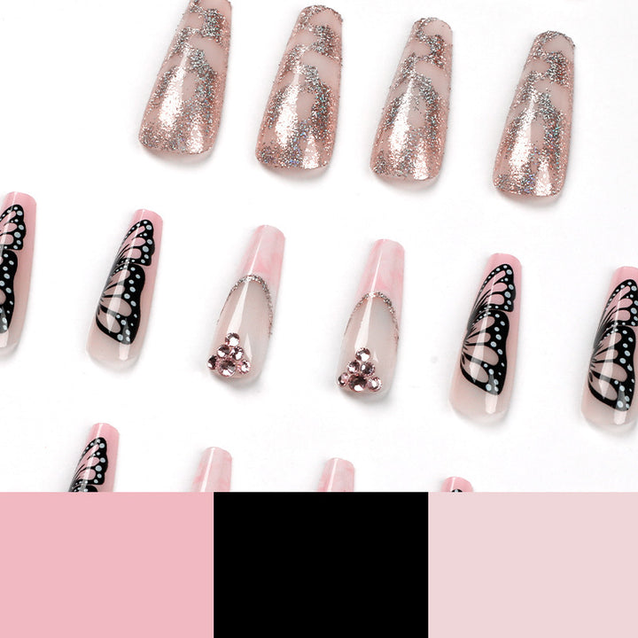 Glamorous nail extensions with beautiful butterfly motifs and glitter accents Stornfield