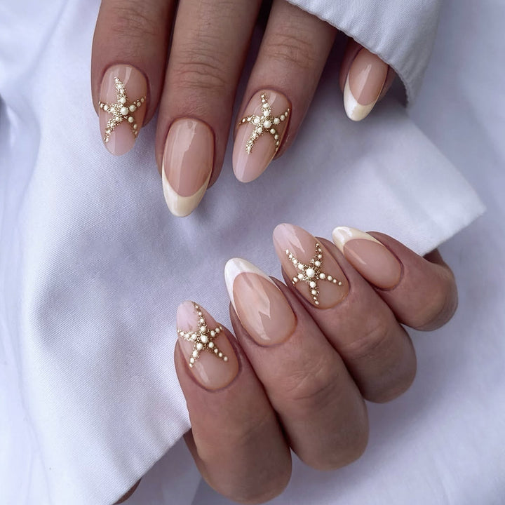 Artificial nail set with delicate pearlescent and glitter accents Stornfield