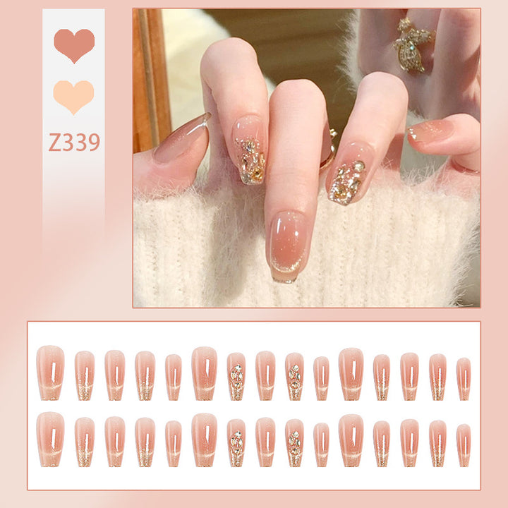 Artificial nail set with sparkling glitter and 3D applications Stornfield