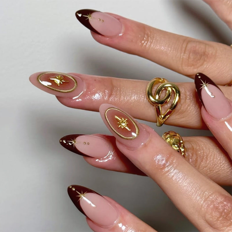 Artful stiletto nails with elegant gold embellishments Stornfield