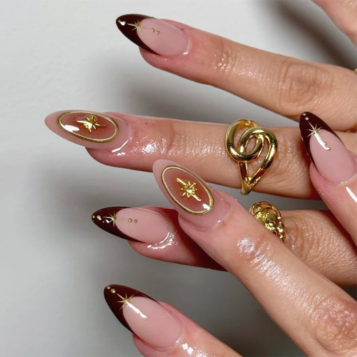 Artful stiletto nails with elegant gold embellishments Stornfield