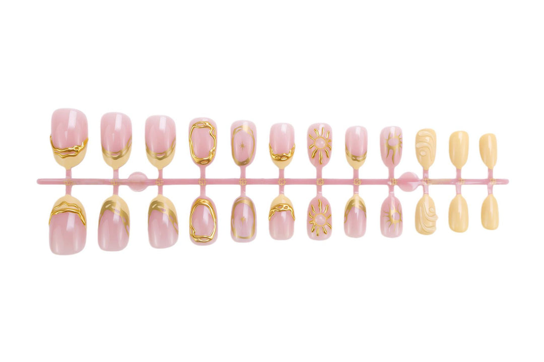 Acrylic nail set with elegant gold embellishments and creative designs Stornfield
