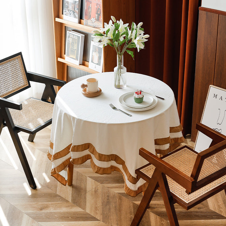 Round tablecloth with quilted textured relief and double-layered ruffle Stornfield