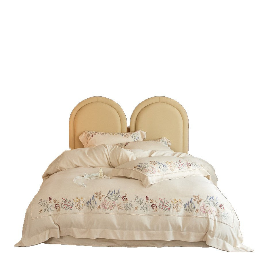 Romantic cotton satin duvet cover set with delicate floral embroidery and decorative pillow