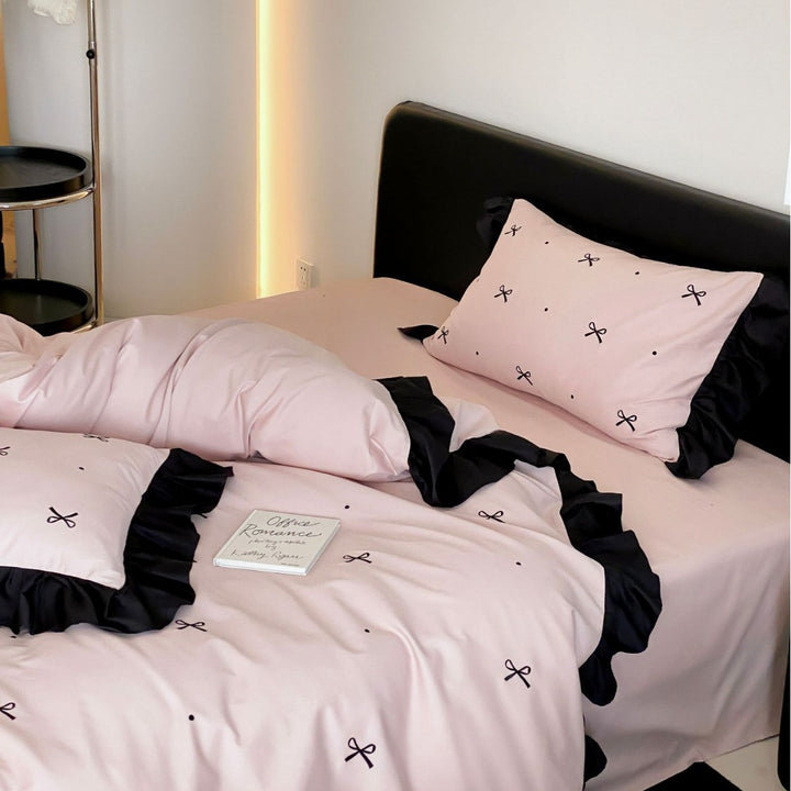 Reversible cotton satin bedding set with fine bow embroidery and ruffled edge